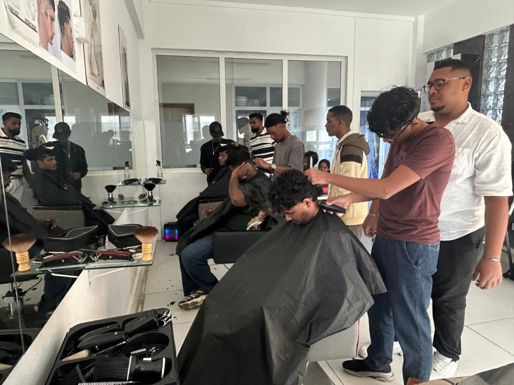 Barbering students in practice